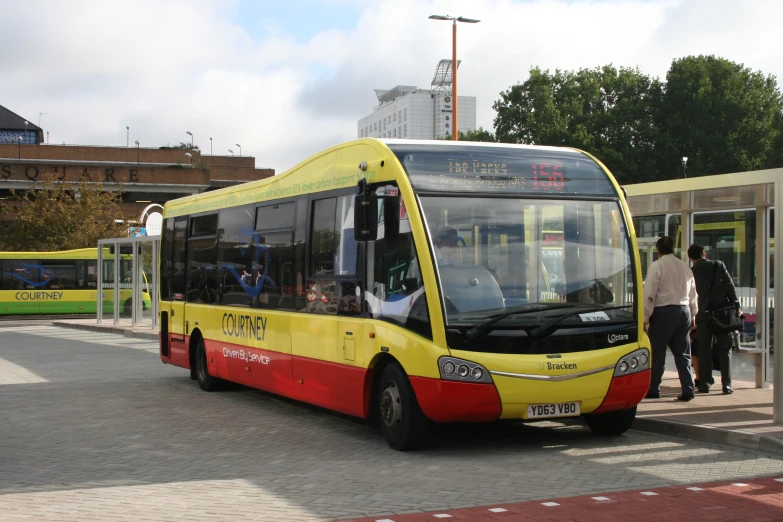 a yellow bus that is parked next to a curb