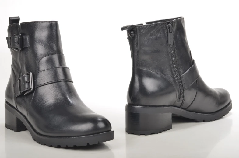 a pair of black leather boots sitting next to each other