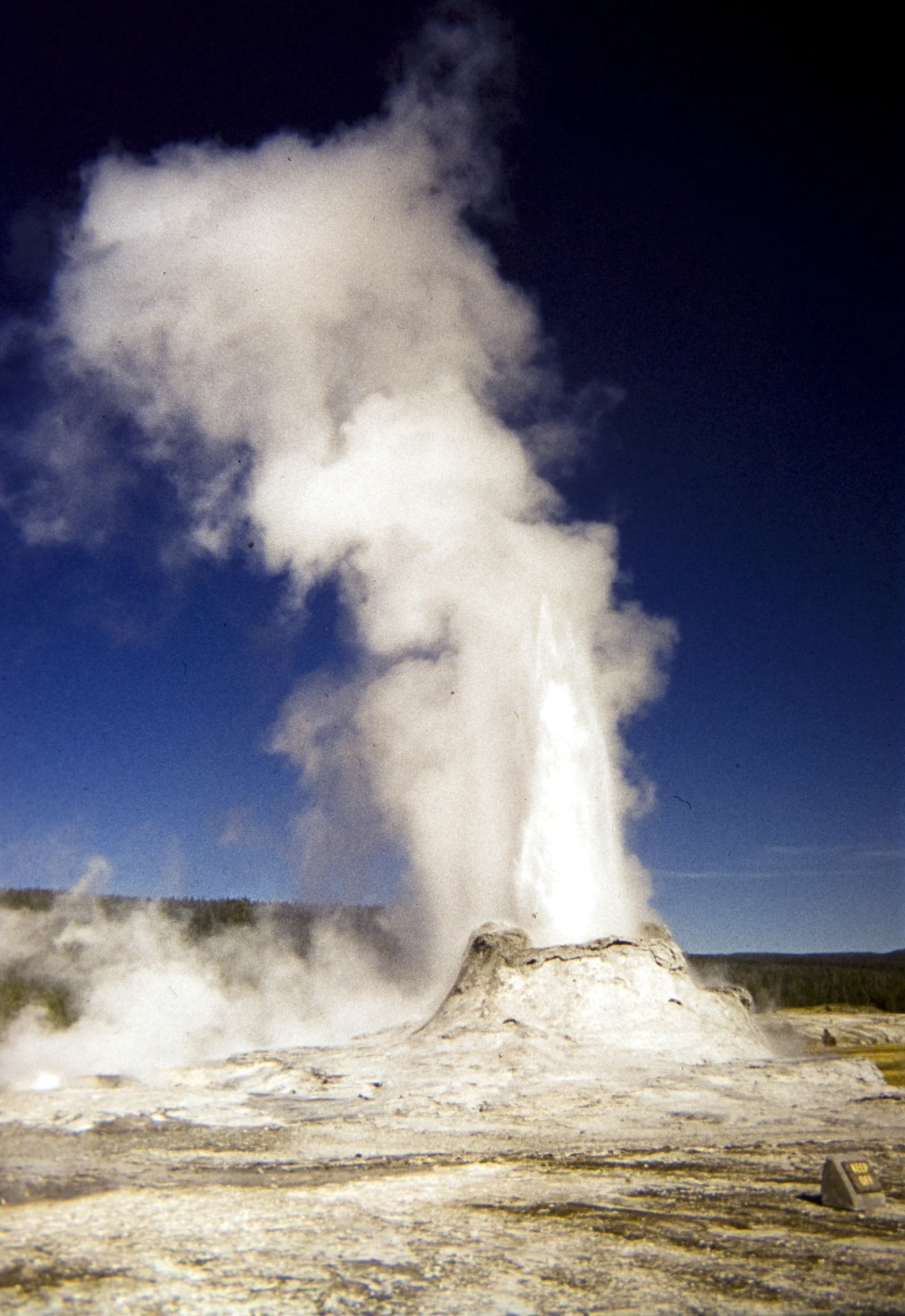 large white cloud of steam billows out of the ground