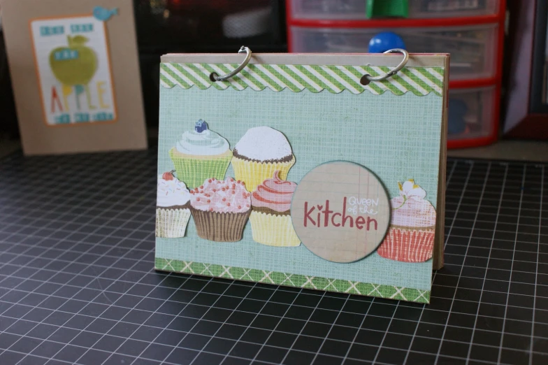 the card features a cutout of cupcakes and the name kitchen