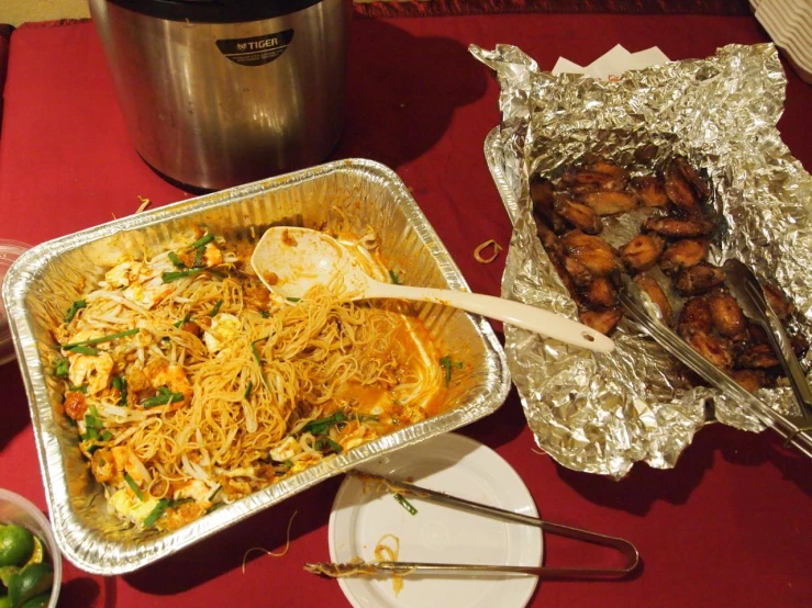 a metal pan sitting on top of a table filled with food