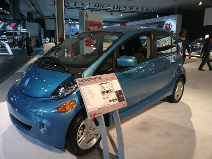 a blue smart car that is on display