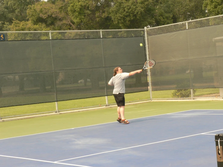 woman about to hit a tennis ball with her racket