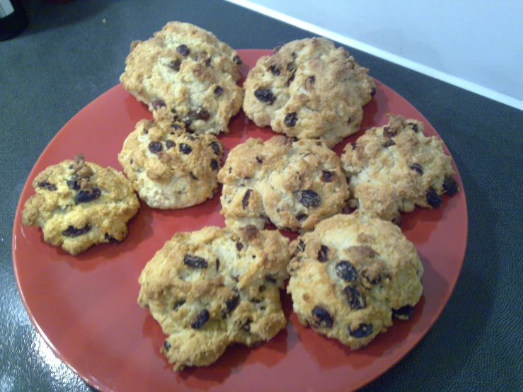 eight chocolate chip cookies on a red plate