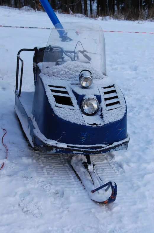 a car is covered with snow on a snowy field