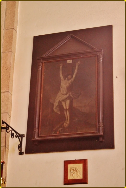 an antique painting hangs up on the wall