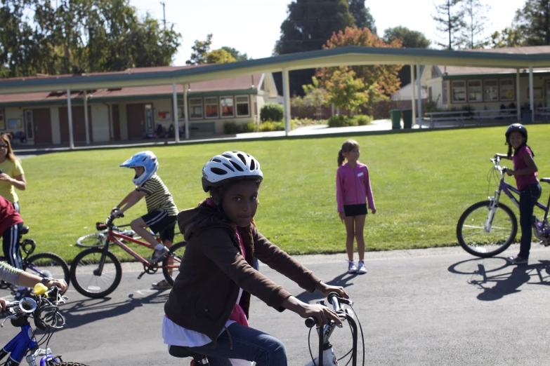 a group of girls riding bicycles down a street