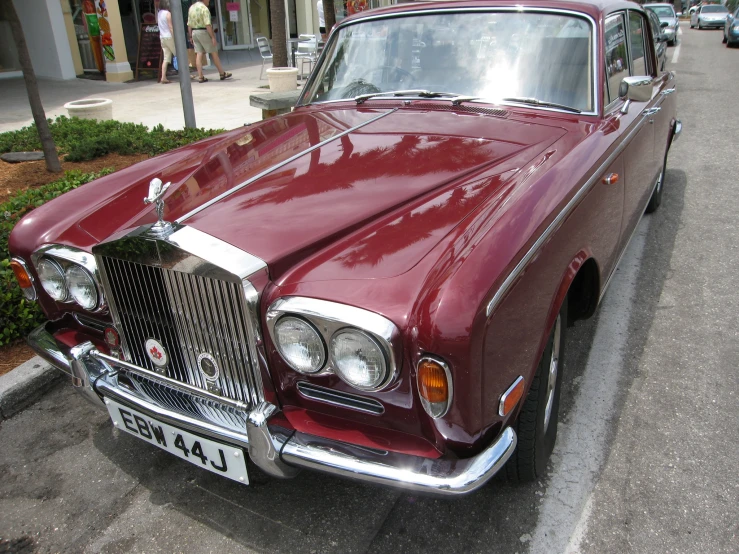 an old - fashioned car parked on the side of a street