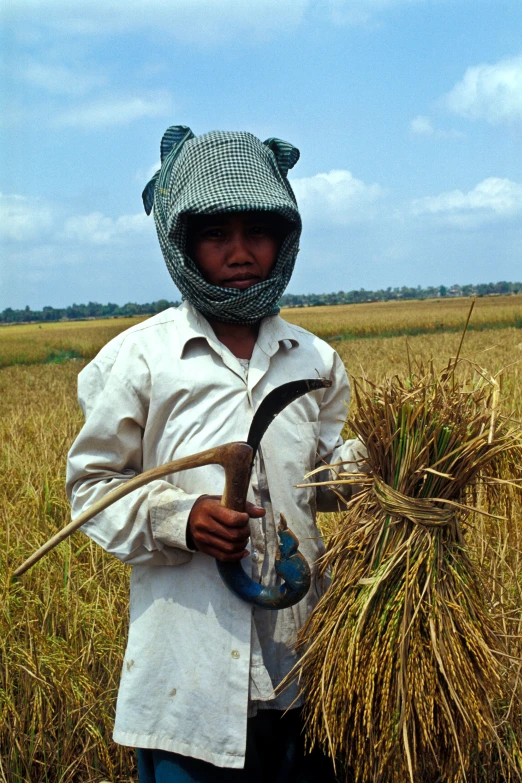 a  holding a metal detector in a field