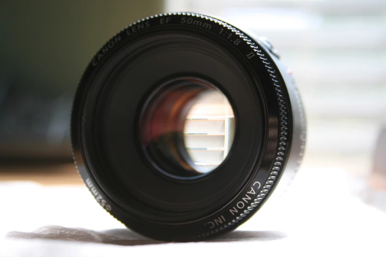 a lens sitting on a counter top with its reflection