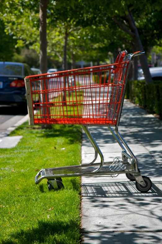 an empty shopping cart sitting in the grass