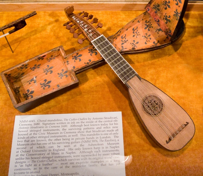 a small instrument on a table next to a pair of plywood instruments