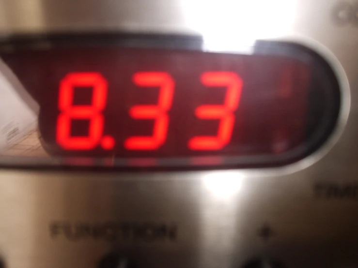 the clock is red as the numbers go down on the oven