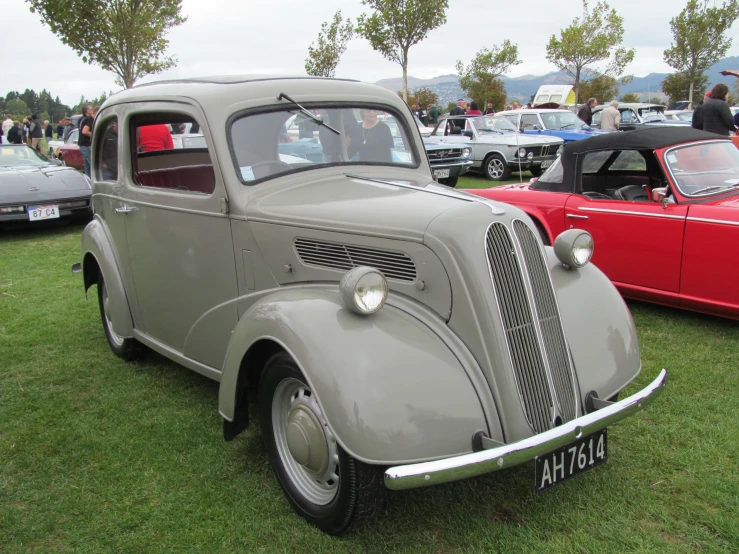 an old car sits parked among a group of other vehicles