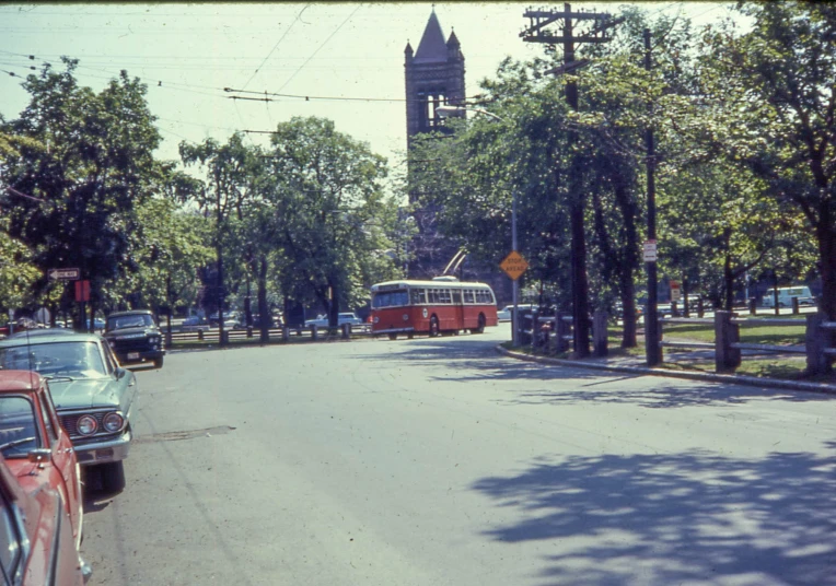 there is a red bus that is moving down the street