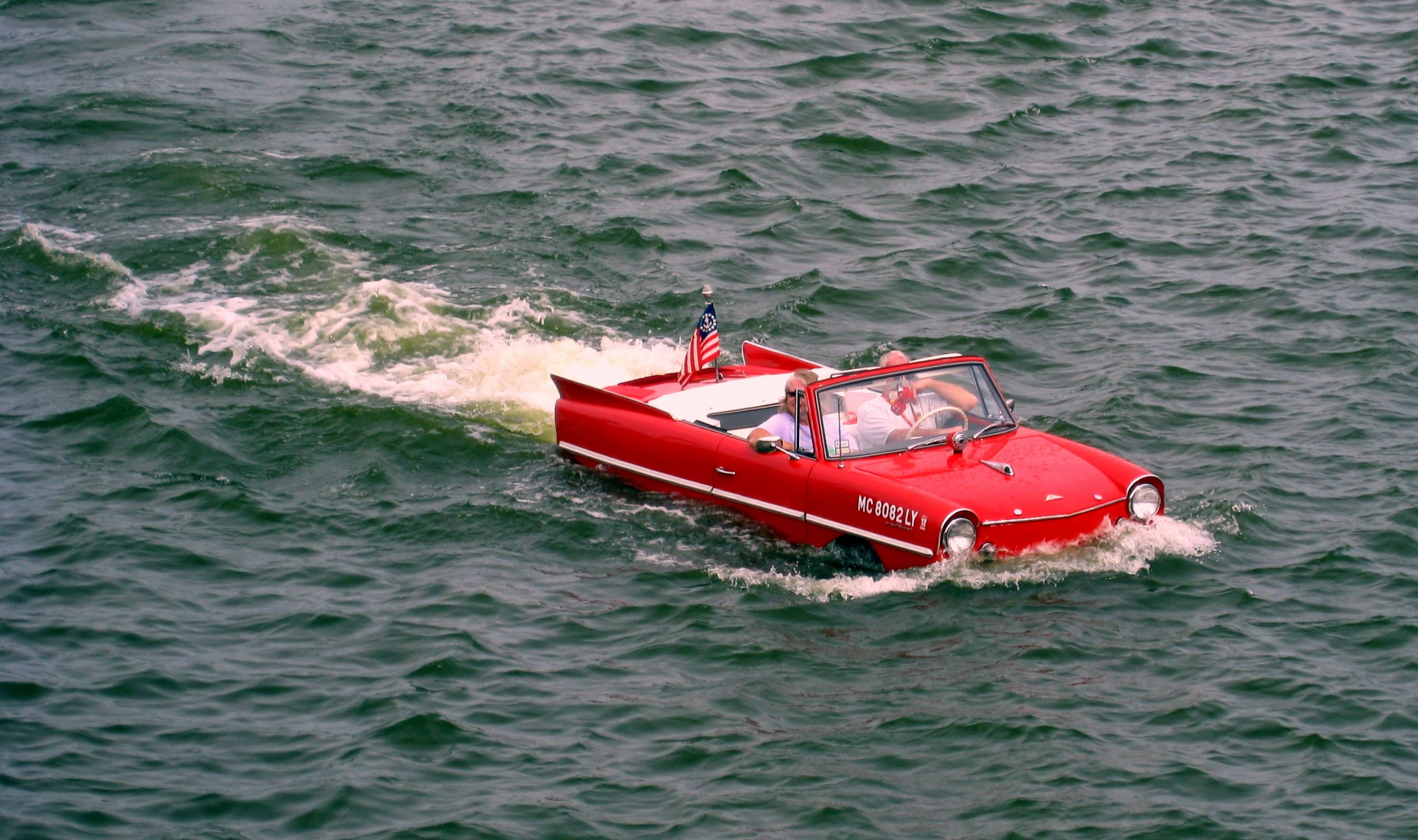 a small red boat on top of the water