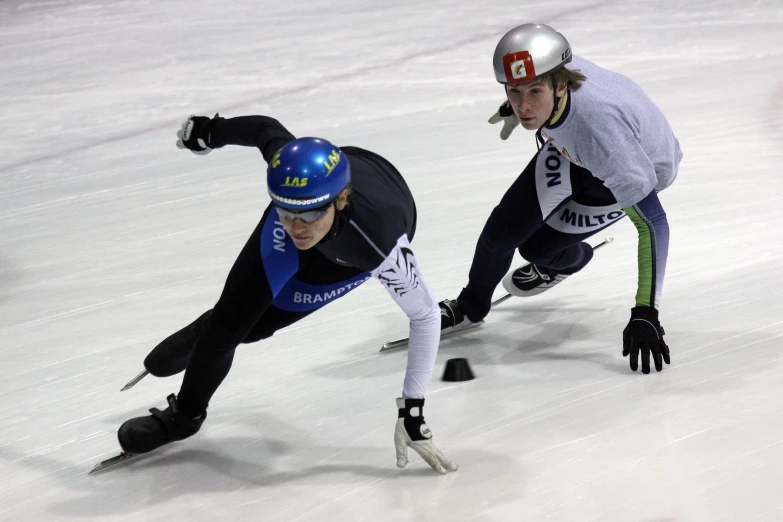 two people are riding on snowboards in the snow