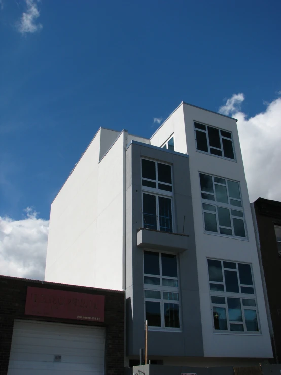 two tall buildings on a sunny day next to a brick building