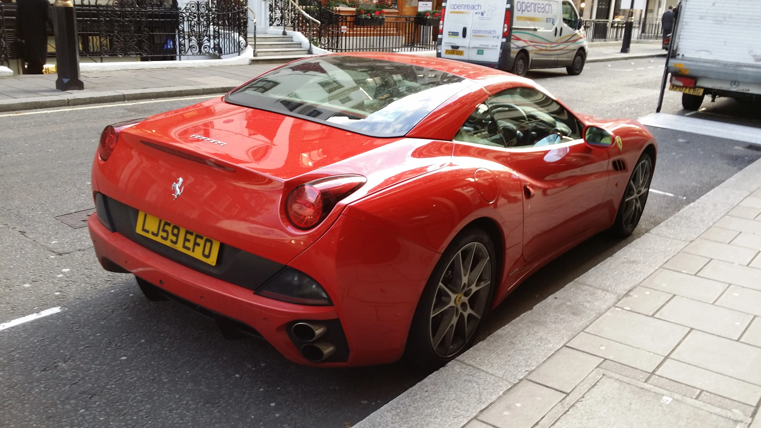 a red sports car parked next to a street
