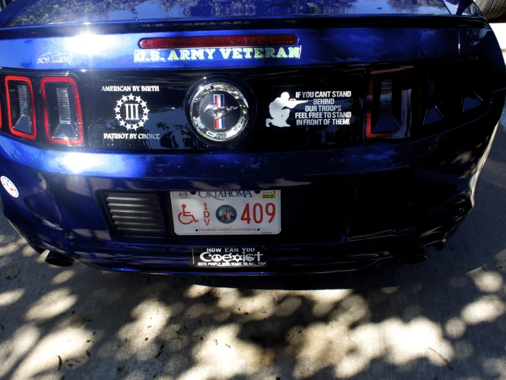 an automobile parked in the shade, on the street