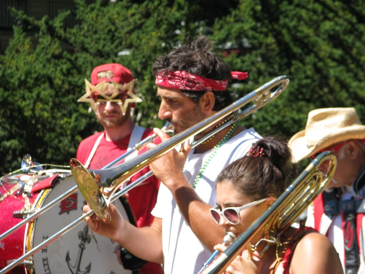 a band that is standing around holding some musical instruments