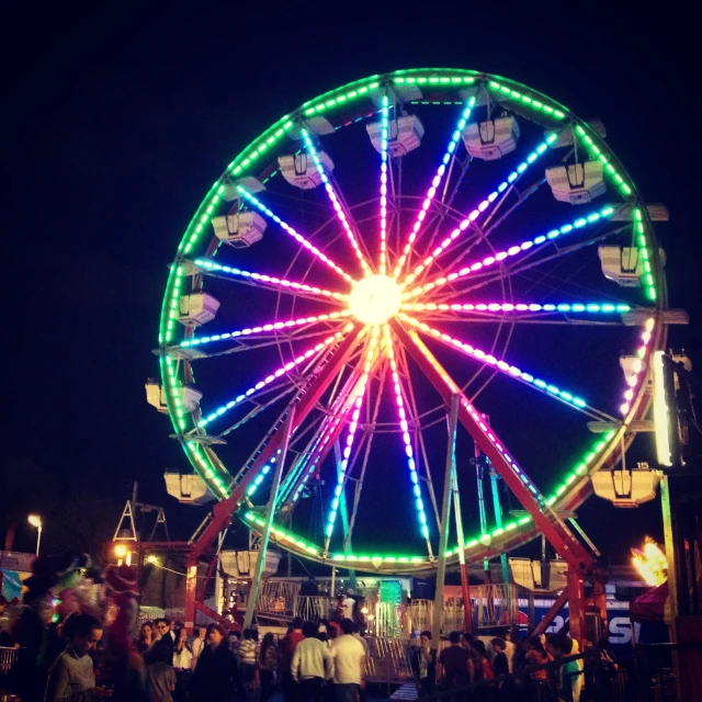 a ferris wheel with many lights inside it