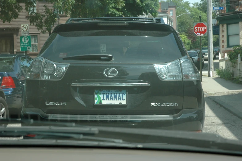 rear view mirror shows on the back end of a black suv