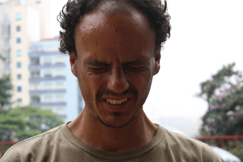 a man standing in front of a street with tall buildings