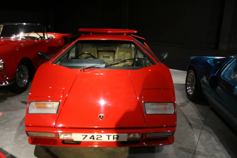 red ferrari sports cars on display at a show