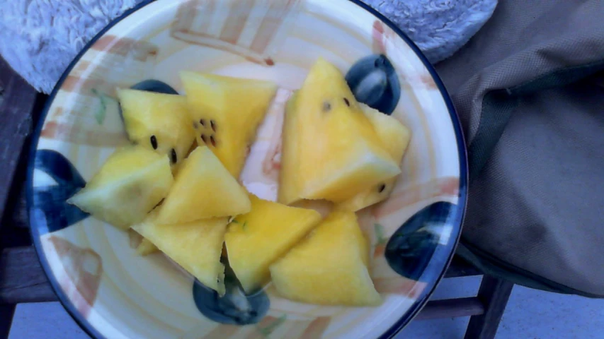a bowl full of cut up pineapple slices