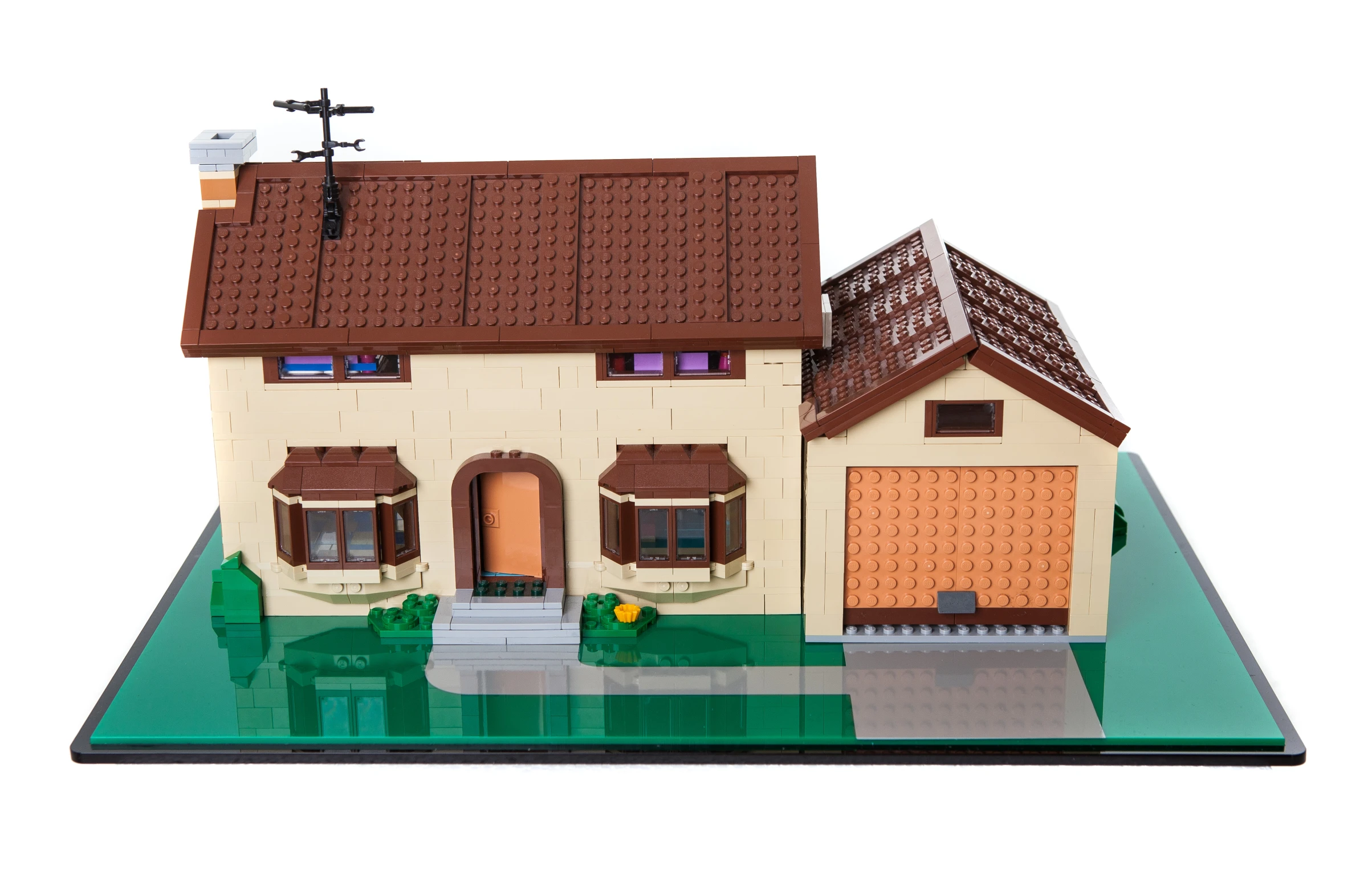 a house made out of plastic with a clock on the top