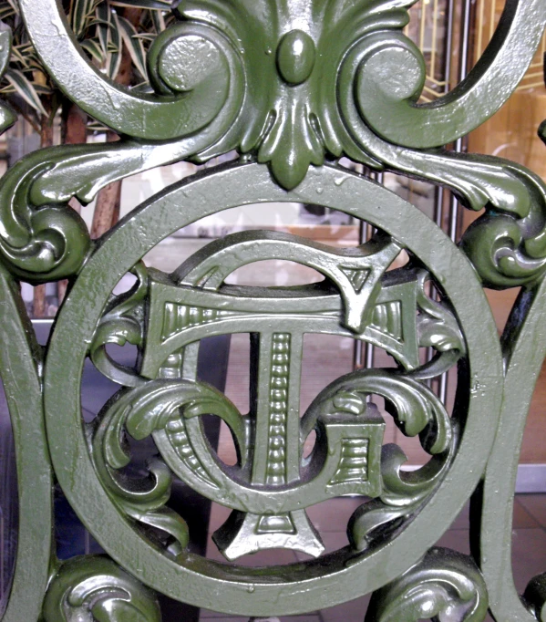 green and silver chair with intricate design
