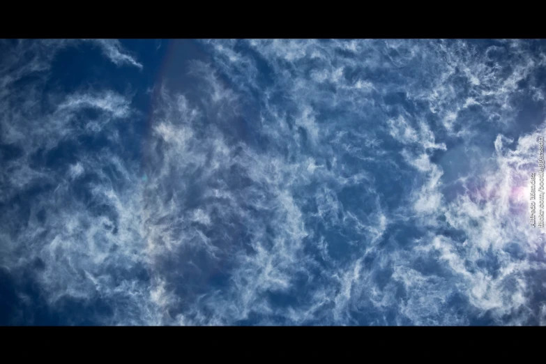 a plane is flying in the blue sky