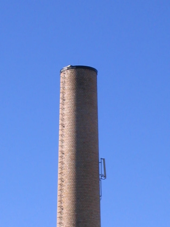 an old water tower with a weathervane on top