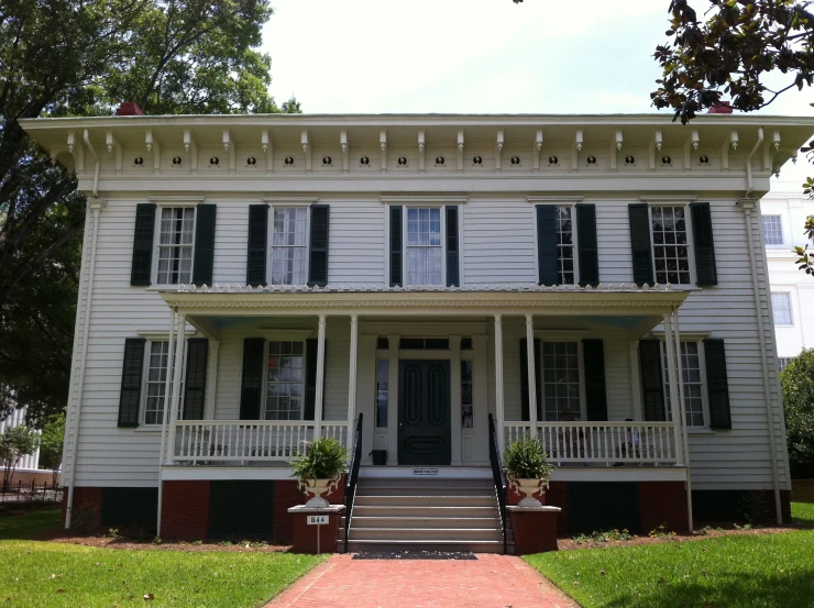 a very large house that has black shutters