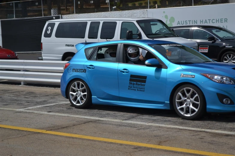 a man driving a car with an ad on the side