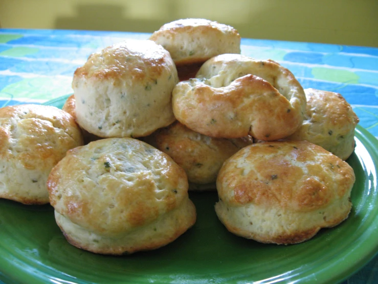 a green plate with lots of small biscuits