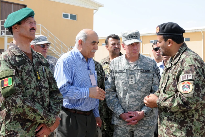 men are talking to one another and wearing military uniforms