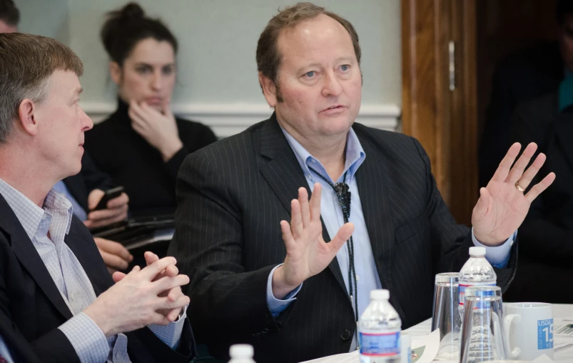 several people sitting at a table during a meeting