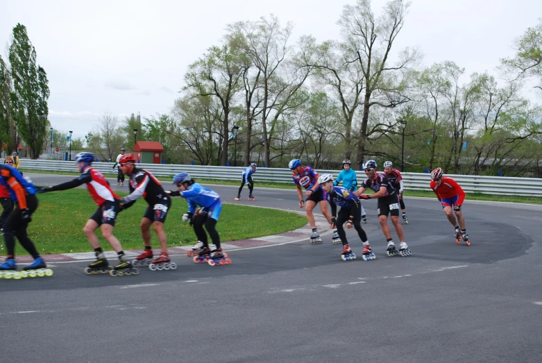 many skateboarders are racing on a race track