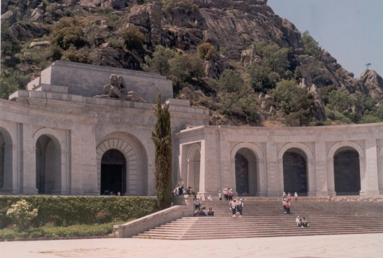 a group of people walking up steps to an archway