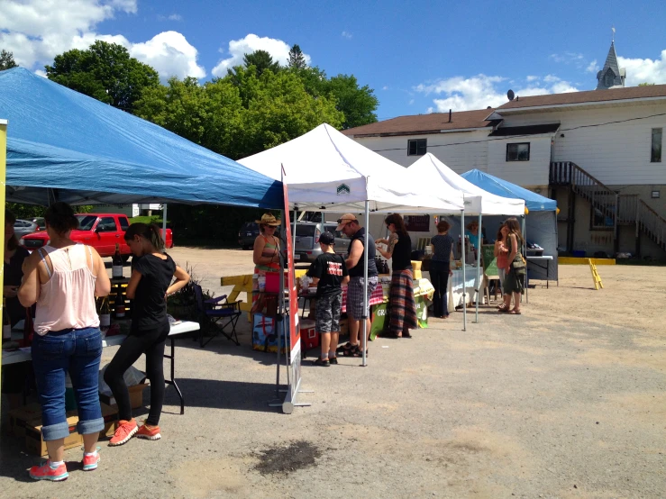 a group of people standing under tents