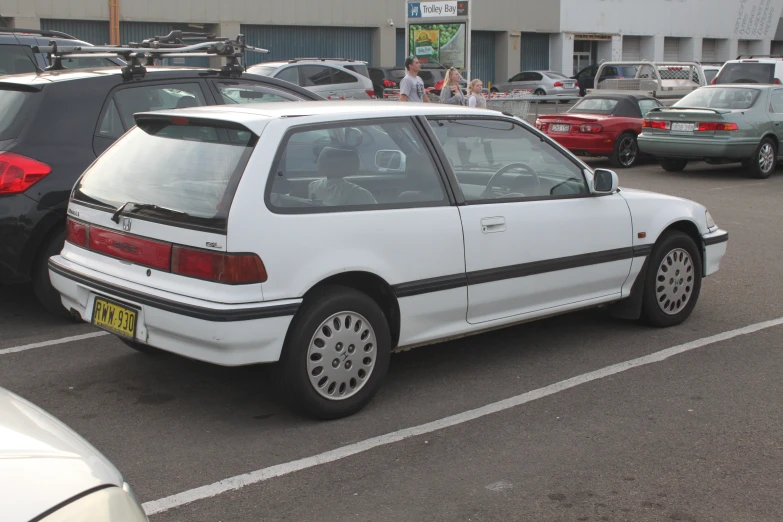 this is a parked white car in the parking lot