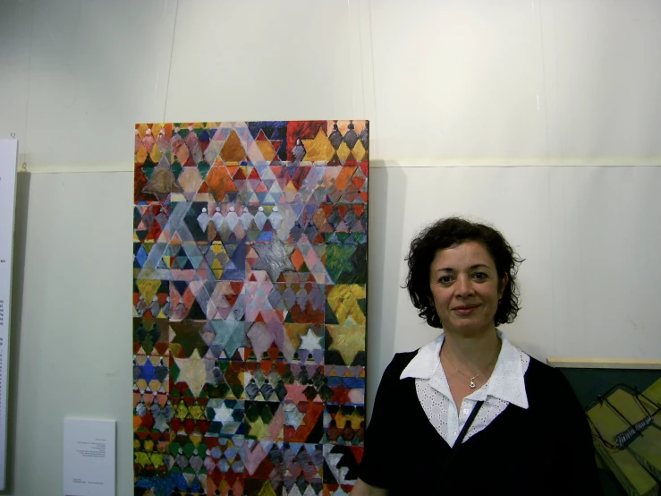 woman standing in front of art displayed on wall