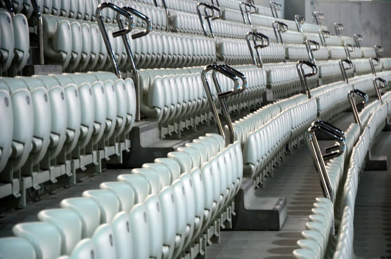 empty chairs in an arena sitting side by side