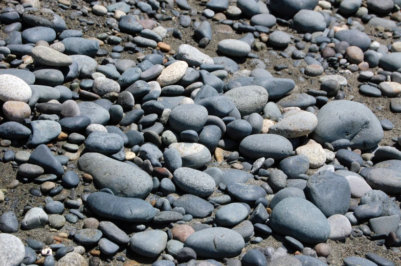 many different colored rocks and gravel on the ground