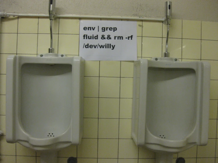 two urinals with lids, attached to the wall