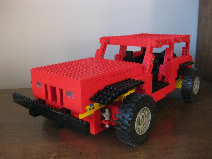 a toy truck built out of legos sitting on a table