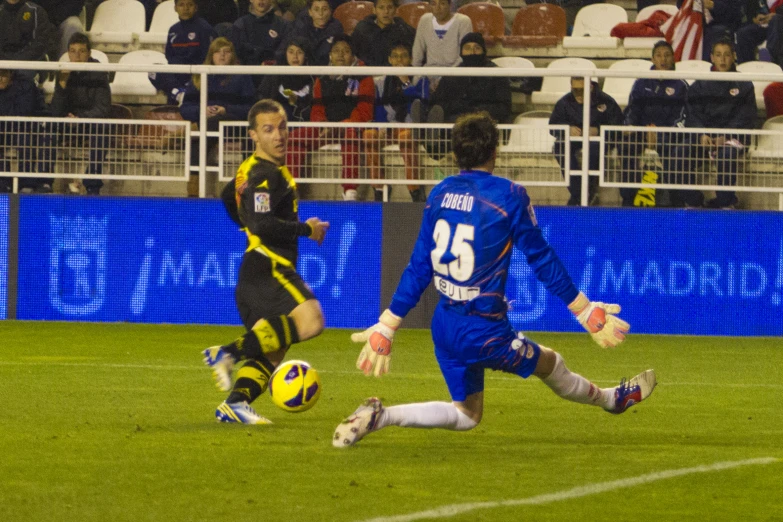 a soccer player runs after the ball while the opposing opponent tries to stop