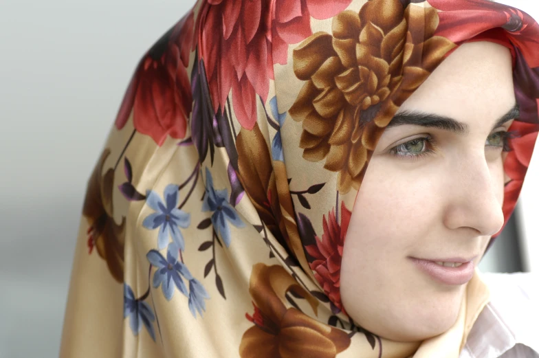 a woman is wearing a headscarf and has a flowered hijab